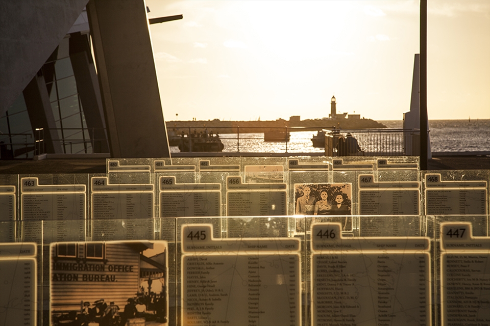 The Welcome Wall's Memorial illuminated by the setting sun  and set against the South Mole Lighthouse are located at the Western Australia Maritime Museum in Fremantle. The wall has 21,000 inscriptions, almost half of the 45,000+ immigrants who arrived by boat in Fremantle & Albany during the  mid to late 18th century and early 19th century.