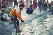 Karmic cycle.
when devotees perform their rituals, they often present an offering of coins to the river. Young street urchins like this one then fish for these coins using a magnet array. This lad was likely new to it, he only had a single small magnet his string, and was timid, almost ashamed. Others were confident and with defiance in their eyes, used huge magnet arrays, up to a meter long to harvest coins from the shallows. 
it was an incredible insight to observe the reactions they received; while some accepted them as part of the cycle, perhaps feeling in-turn, through their devotion the gods are providing money for these children. Some showed distain, and it seemed they felt they were undermining their ritual by stealing the coins they'd offered: by danielhaley, Views[1190]