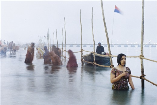 Devotion.
For more than half an hour I stood waist deep with my tripod and watched rapt in awe at the depth of her faith. Others come and went, merely splashing water, clapping hands and mumbling words several times as if following some cosmic recipe. meanwhile, as the Ganges freezing waters swirled past her gentle body; this young woman stood, still as a tree.
Emotions poured through and radiated from her compassionate form, and she truly purified herself