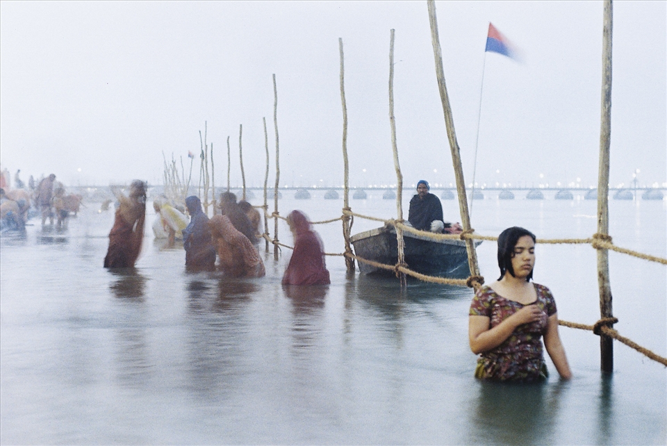 Devotion.
For more than half an hour I stood waist deep with my tripod and watched rapt in awe at the depth of her faith. Others come and went, merely splashing water, clapping hands and mumbling words several times as if following some cosmic recipe. meanwhile, as the Ganges freezing waters swirled past her gentle body; this young woman stood, still as a tree.
Emotions poured through and radiated from her compassionate form, and she truly purified herself