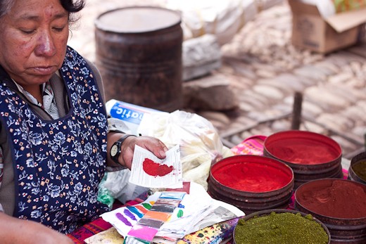 The vibrant colors of the natural dye booth caught the eye of both tourists and locals alike. Here, the vendor demonstrates which natural dyes she mixes to create her preferred  perfect shade of red. 