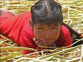 A young girl pierces my camera lens on a reed island on Lake titikaka.: by daniellewatkins, Views[299]