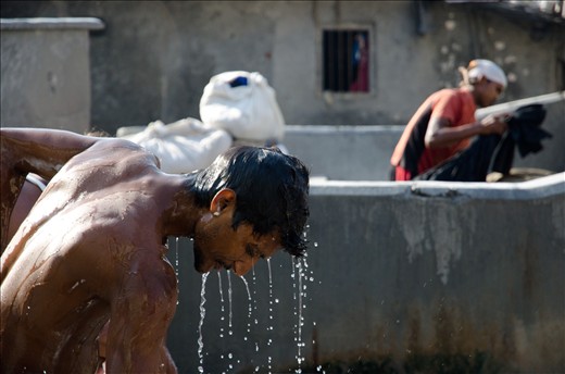 Worker washes himself after finishing his work.