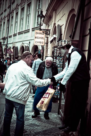 Street performer engages with a tourist in the Old Town.