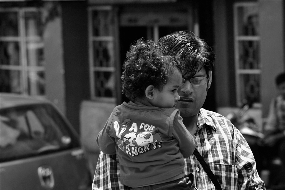 TOURIST WITH HIS BABY. TOURISM IS THE MAIN FINANCIAL SUPPORT OF DARJEELING.