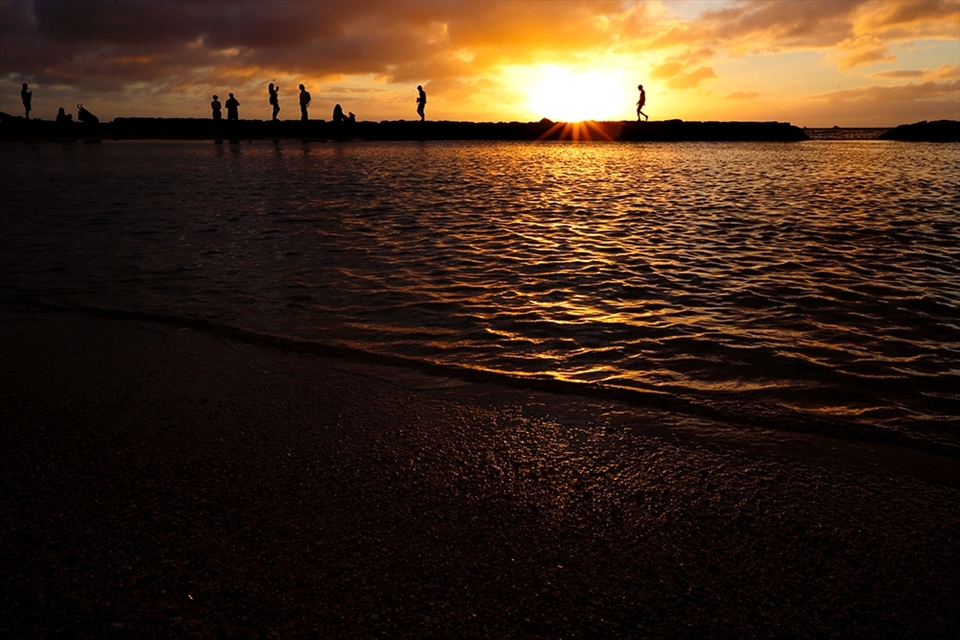 Honolulu Hawaii; Waikiki Beach. People pour out of the city onto the pristine beaches.