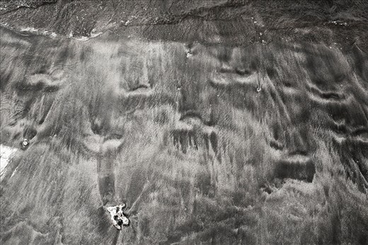 Footprints in the Sand. Walking the beach in Lahaina I got interested in the coulours, contrast and textures of the sand. It was not your usual white sand beach. A group of local girls walked past and I snapped a shot of their footprints as a wave washed them away.
