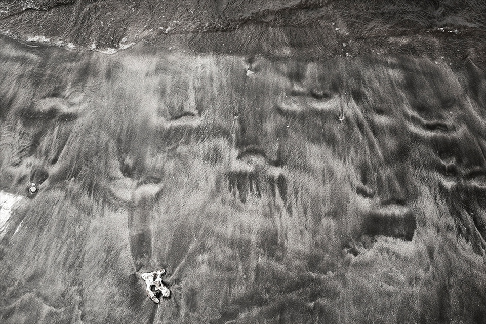 Footprints in the Sand. Walking the beach in Lahaina I got interested in the coulours, contrast and textures of the sand. It was not your usual white sand beach. A group of local girls walked past and I snapped a shot of their footprints as a wave washed them away.