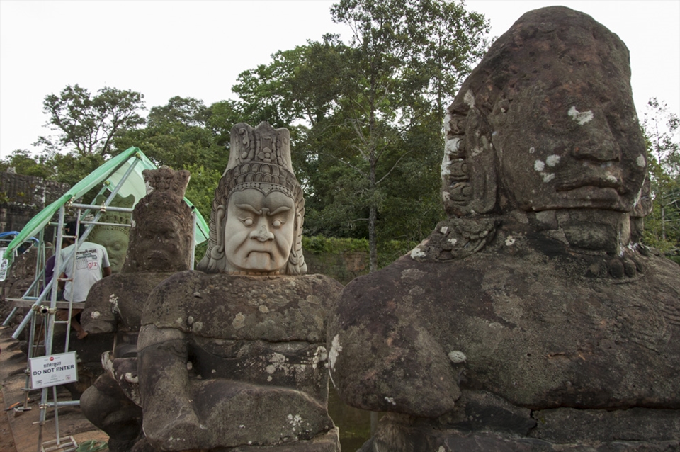A group repairs the original sandstone carvings.