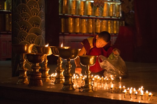 The light within: a young Monk tends lamps in a monastery in Ulaanbaatar. Despite the murder of thousands of monks and the desecration of monasteries by the Revolutionaries in the early 1920s, the practice of the religion persisted. Today upwards of 90% of Mongolians consider themselves Buddhist.