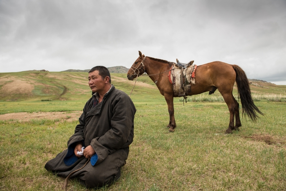 Welcoming party: bearing traditional fermented mare’s milk, or airag, a man from a remote enclave rides out to meet us. In Mongolia, the fate of human and horse is inexorably intertwined, and Mongolian children seem at home in the saddle even before they are steady on their own feet.