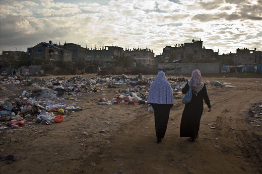  Palestinian women walk home near the Nuseirat refugee camp, Gaza
