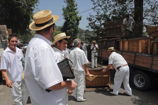 At the top of Madeira's famous toboggan run, toboggan driver’s wait for the wicker sleds to be off loaded. 