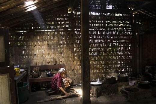 A Javanese lady in her traditional kitchen evironment