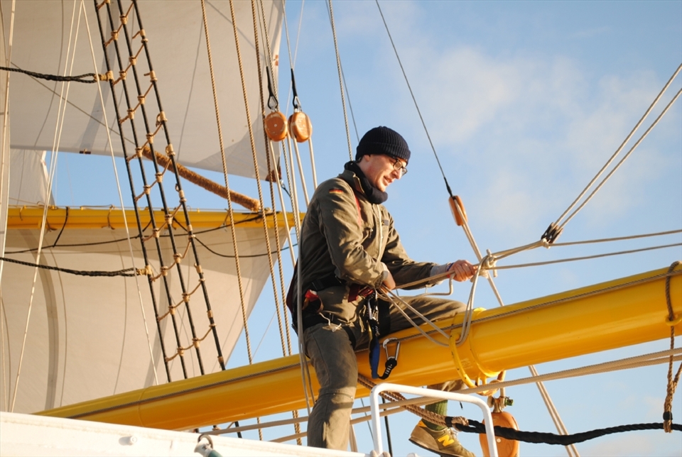 The morning after. A crew member straddles the boom making repairs before we made port in Dublin. If was shortly after sunrise and the mood on board was jubilant as we had claimed second place in the race and survived the big storm.