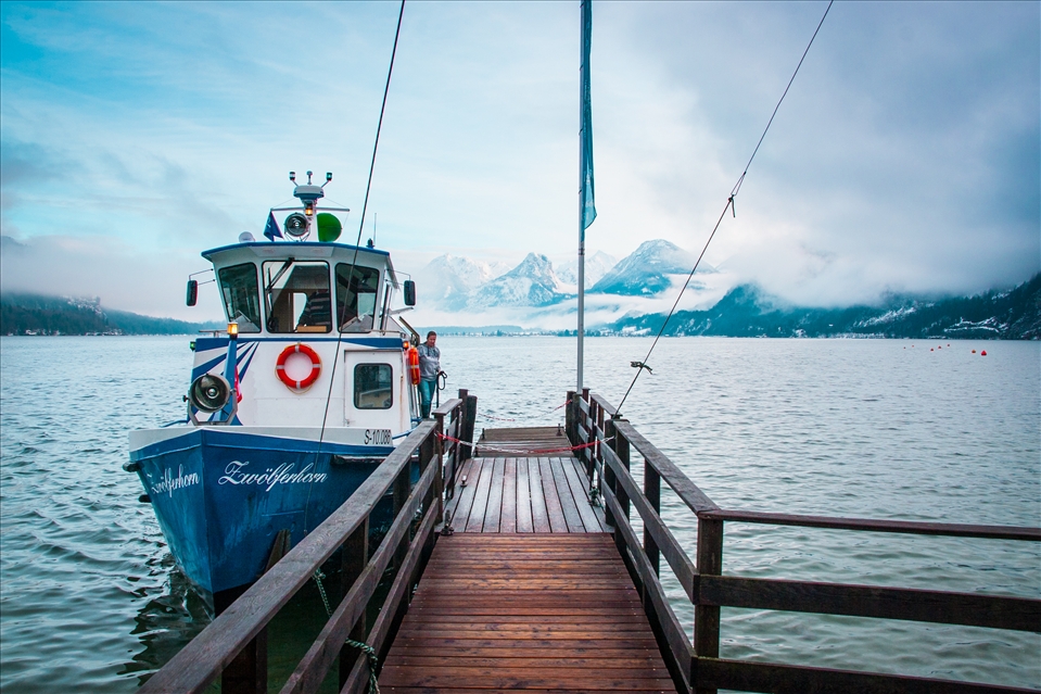 Eventually I reached the shores of lake Wolfgang and was greeted with a magnificent view of the mountains shining though the clearing clouds .The sun was setting and gave the peaks a magical yellow hue, while the lake was crystal clear emerald, despite the surprisingly large number of ships… This must have been a patrol boat arriving from another town on the lake.