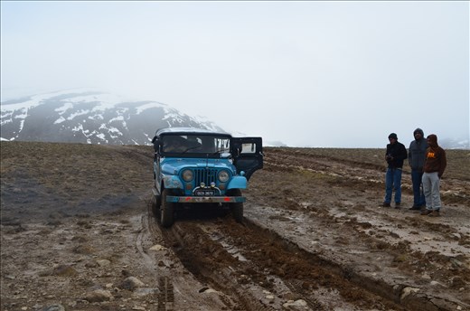 Jeep stuck and three of my friends waiting to get out in cool breeze.