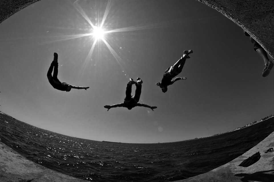Libyan rebels enjoying a little R&R by jumping into the Mediterranean Sea.