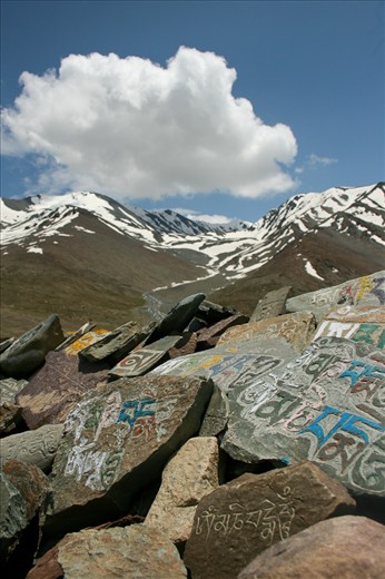 Mounds of 'mani' stones dot the landscape as offerings to local spirits, inscribed with Avlokiteshvara's chant 