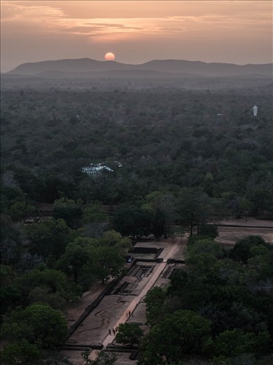 Sunset from the top of Sigiriya rock with Buddha statue far away