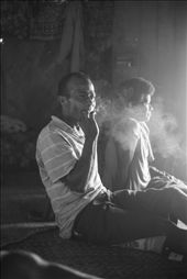 A man enjoys a cigarette in between rounds of kava with friends. Kava, though traditionally drank at ceremonies or important occasions, is a social activity that many do in Navala to pass the time. As a subsistence farming based community, most men work on the ranch or farm to provide for their family. On afternoons off, such as this one, it is not uncommon for groups of individuals to gather in a bure (traditional Fijian house) and have a few rounds of kava whilst exchanging jokes to unwind.: by devonhanna, Views[656]