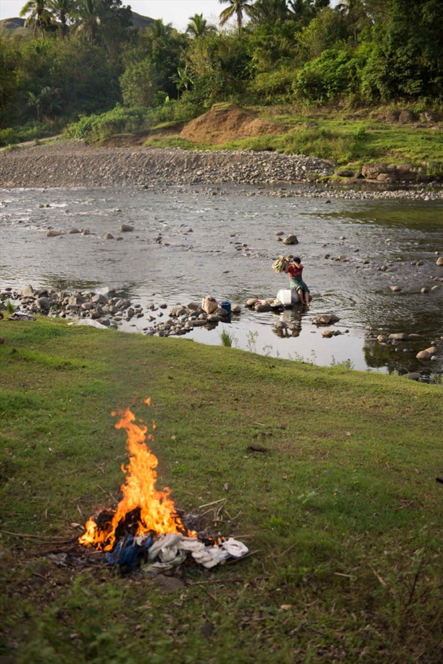 Teresa burns off rubbish whilst washing her family's clothing down on the river. Division of labour is obvious in Navala. For the most part, men work on the local farm and ranch whilst women work in the home. Regardless, women's contributions should not be ignored. Womens groups are common throughout many Fijian villages. Navala's womens group gathers often to arrange fundraising and to discuss local events. The night prior to this photo being taken $300 was raised at a meeting for new school carpets and curtains.
