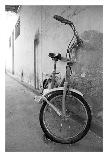 Old & Rusty Bike sitting in the porch of my husband's grandmothers house. 