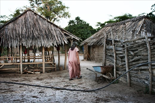 2.	A wayuu woman dressed in her traditional tunic walks in her Rancheria. Most W