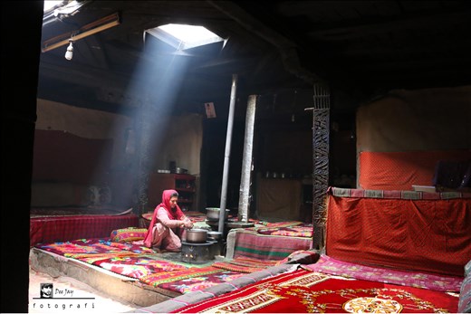 A Wakhi/Pamirian cooking traditional food in her traditional setting