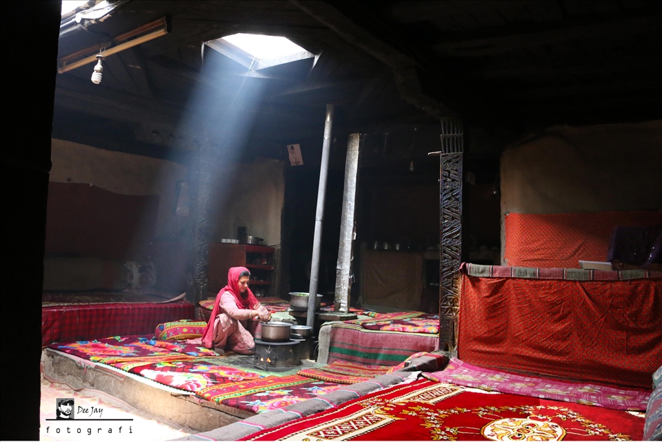 A Wakhi/Pamirian cooking traditional food in her traditional setting