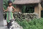 A young Black H'mong girl waits patiently with one of her three dogs while her parents prepare the evening meal.: by dillan, Views[835]