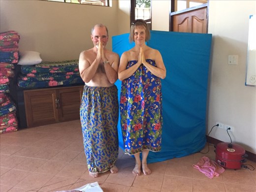 Aaron and Dina in our sarongs, ready for the herbal steam room (in the background).