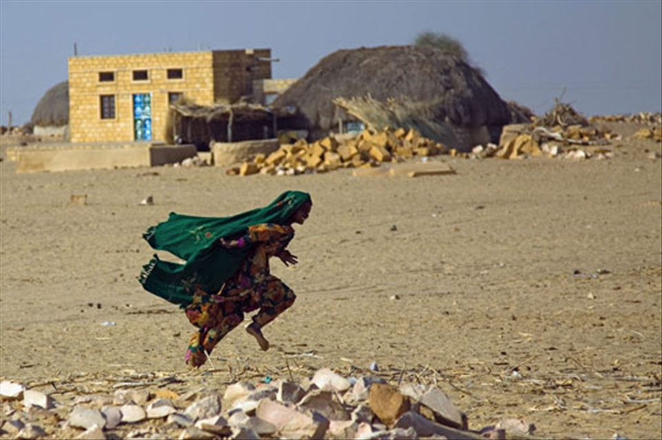 A little girl playing and smiling at the photographer a few minutes before had a red nose. The little girl had never seen a clown in his life