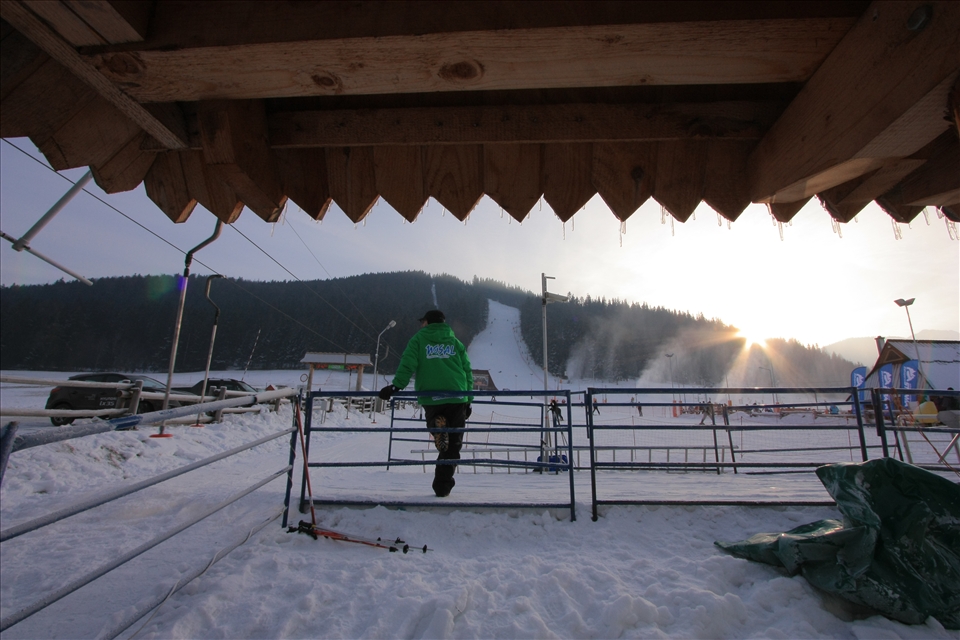 A worker at Nosal Ski Area watches the people while the sun is setting.