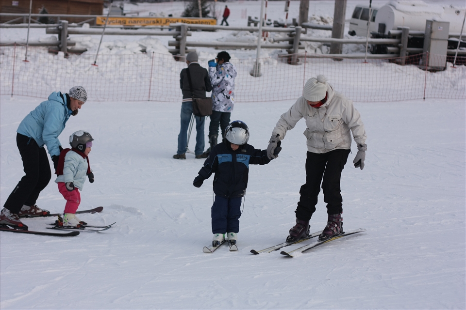Two mothers teaches her children skiing at Nosal Ski Area.