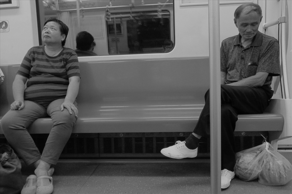 People in the Shanghai metro. Close to each other but in their own thoughts.
