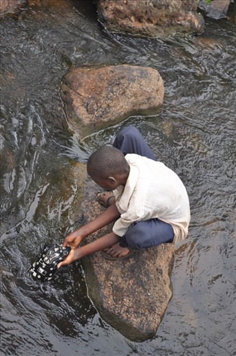 Meet Peter, our tour guide. Peter is an 11 year old boy, who spends his days taking the tourists on a hike from the top of the falls to the bottom. This is their 7 member family's only source of income. In this photo, Peter washes a cap that one of the American tourists dropped on their hike to keep for himself because he tells us that other than the clothes he has on his back, he has 2 other pairs.
