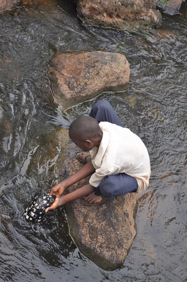 Meet Peter, our tour guide. Peter is an 11 year old boy, who spends his days taking the tourists on a hike from the top of the falls to the bottom. This is their 7 member family's only source of income. In this photo, Peter washes a cap that one of the American tourists dropped on their hike to keep for himself because he tells us that other than the clothes he has on his back, he has 2 other pairs.