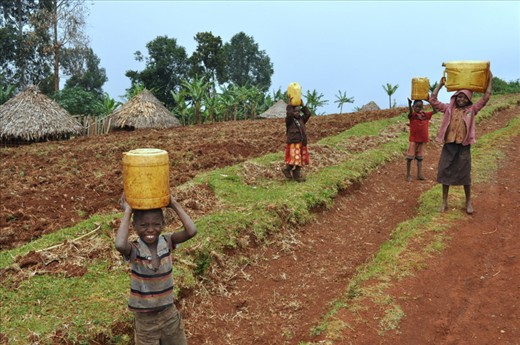 On our drive in a 4-wheel-drive Pajero from the falls to our hotel, we are met with 4 young children of the local community walking to their village after having collected water from the falls for their domestic use.