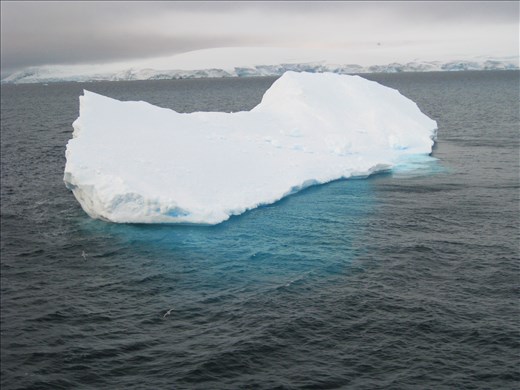 Icebergs breaking off from the continent and melting away
