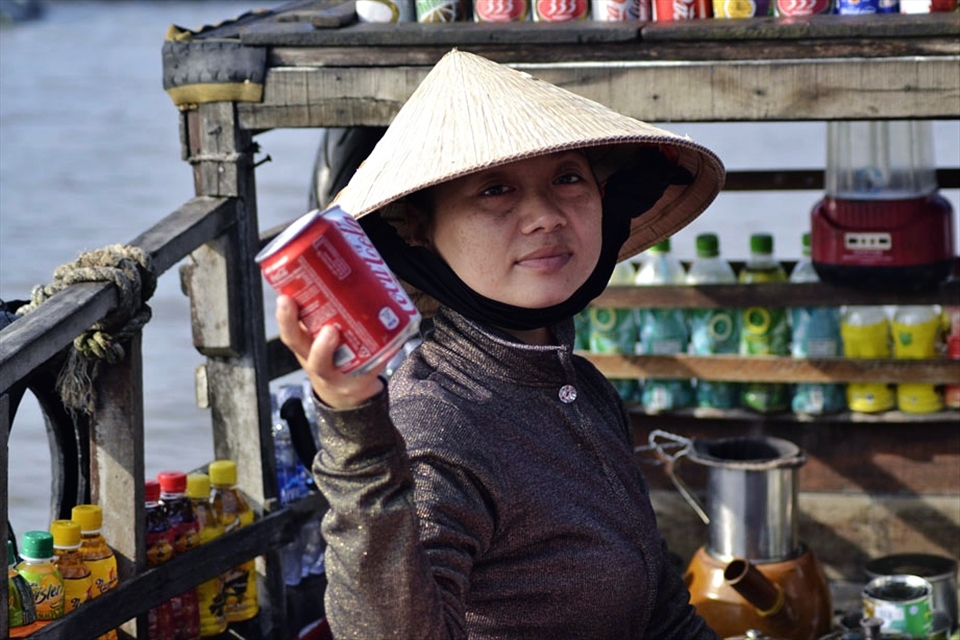 Woman selling Coke to Westerners
