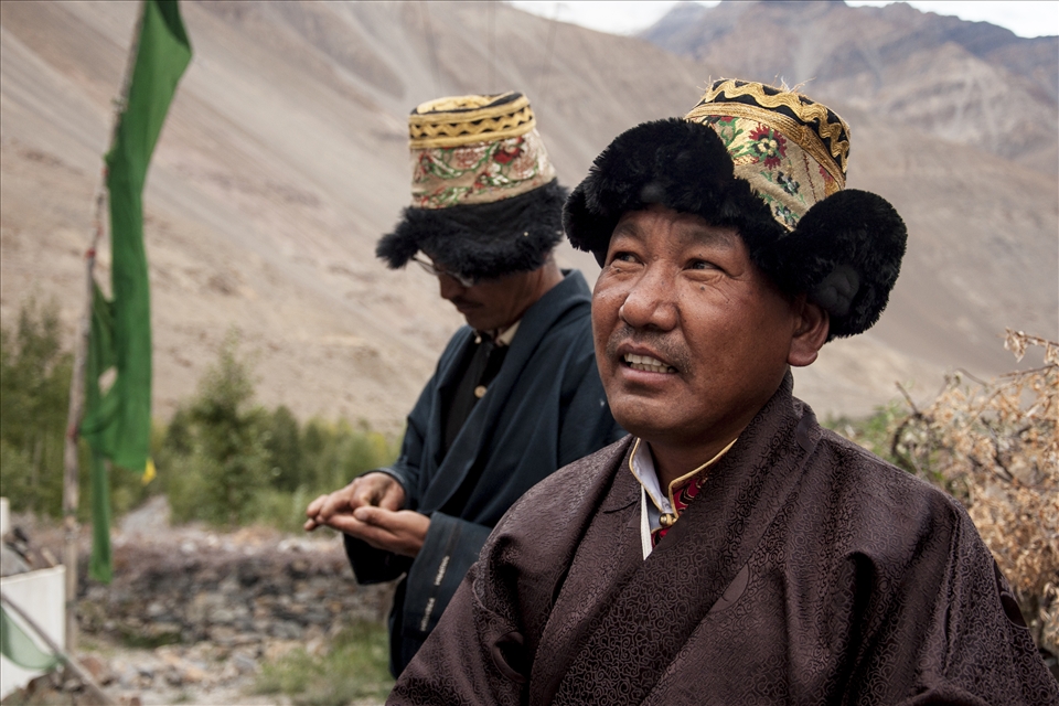 The community is nearing the crossroads of preserving traditions or embracing the modern, with younger generations having migrated for work to urban cities have started finding traditional practices unnecessary. In an attempt to preserve the heritage, interestingly, a fine of Rs. 200 (roughly $ 4) is taken by the village council if one fails to stick to the “dress” code. Dressed in chollu, the traditional attire, resident Tashi Tenzing observes the final leg of the proceedings as light blends into twilight. 