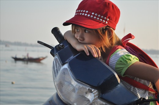 A bored little girl waits for her parents to finish work.