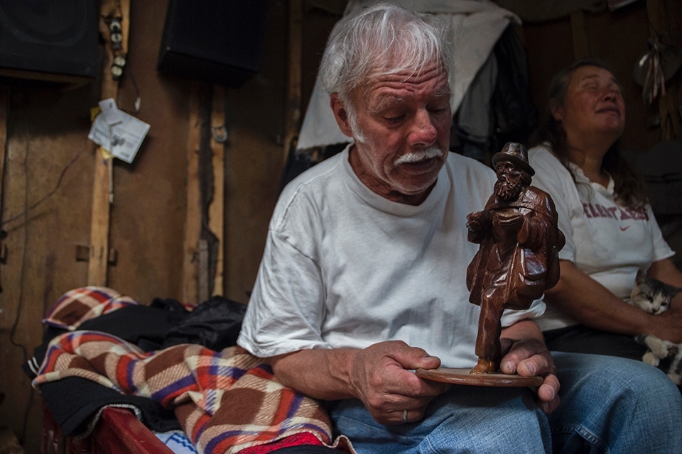 Because of his age, no one wants to give him a job, but he has struggled and became a self-taught carpenter, making a living on what he creates (If he is lucky enough to sell his handicrafts)