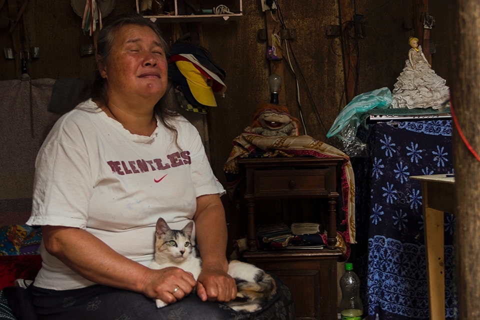 Luz Stella his wife, who is totally blind stays at home doing the chores and taking care of the cat.