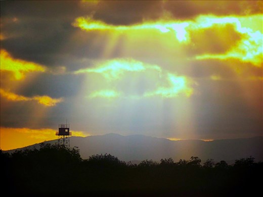 Sunbeams breaking through the clouds, A watch tower keeps an eye on the enemy.