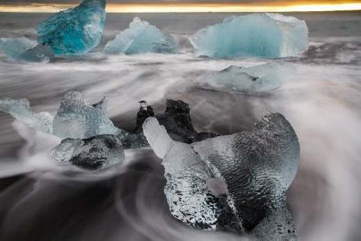 ocean shapes the chunks of ice - first pushing them to shore then strugling to drag them back