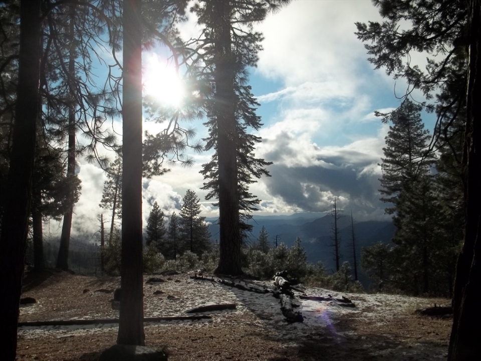 Overlooking the Yosemite Valley, my first campsite is illuminated by the setting sun peaking through the clouds.  The shadows from the trees sporadically cover the snow and fallen trees.  It was my first night backpacking in the wilderness and led to many more backpacking trips. Shot with my Kodak Easyshare c195