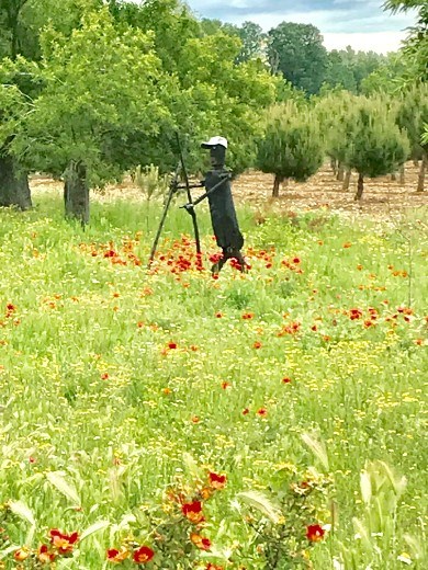 Camino hiker statue in field Villovieco