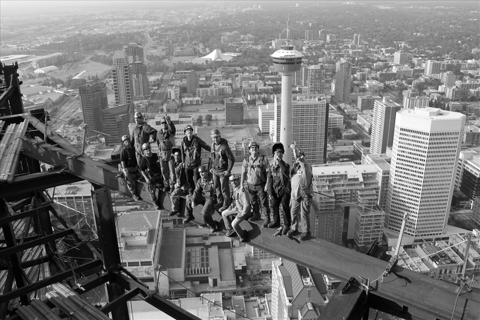 Here is a great example of all the workers becoming kids again. The plan was to get all the workers to look up at me, on the unfinished top floor which I was laying down on. Instead they all broke out with smiles and laughter. This view served a second purpose as well, giving a sense of depth while zoomed out of the structure. Now you can see how its nearly a strait drop, at the same time the natural ease they have gives a nice balance.